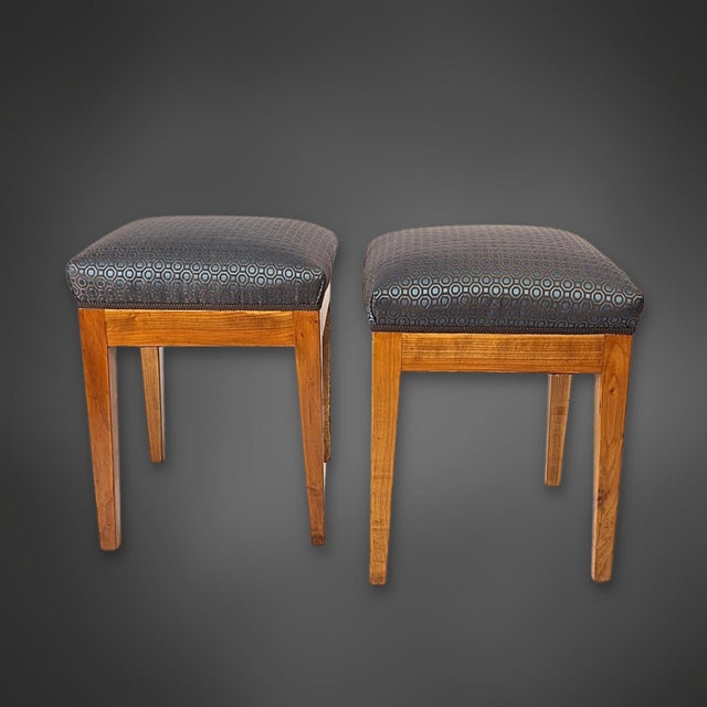 A beautiful pair of stools from the Biedermeier period, circa 1825, crafted from solid cherry wood. The clean lines, warm...