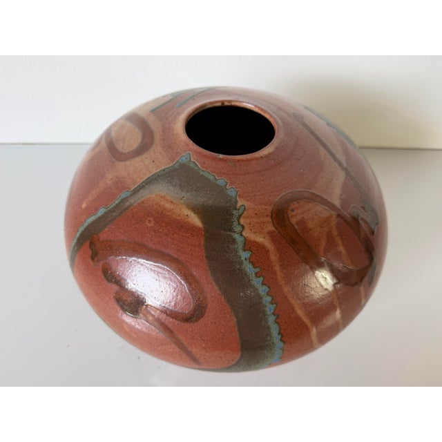 Beautiful vintage handmade studio pottery vase featuring a low, rounded organic form with a rich brown glazed finish...