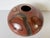 Beautiful vintage handmade studio pottery vase featuring a low, rounded organic form with a rich brown glazed finish...