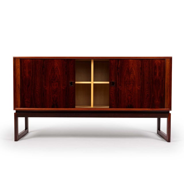 Designed by Axel Christiansen Odder and crafted in Denmark during the 1960s, this exceptional rosewood sideboard...