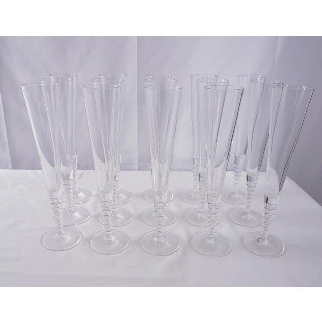The Steuben “Evening” Art Glass Fluted Champagne Glasses by renowned glass artist Dante Marioni form a striking set of 16,...
