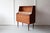 An exquisite teak bureau from Denmark, with three large and two small drawers, an open book shelf and a pull out table...
