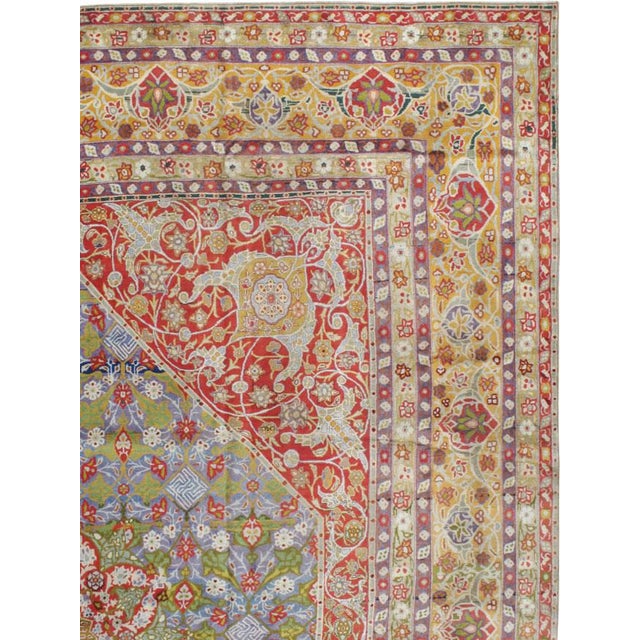 This early 20th-century Persian Tabriz carpet presents an elaborate central medallion composition in soft blue, sage...