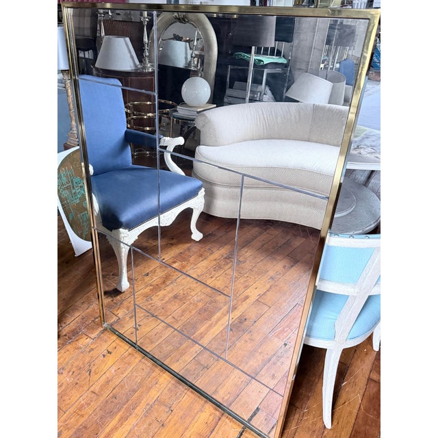Beautiful pair of decorative wall mirrors by Williams Sanoma. These large-scale wall mirrors feature aged smoked mirrors...