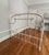 Beautiful antique white full-size bed frame featuring ornate detailing, conical plugs, and a sturdy heavy iron...