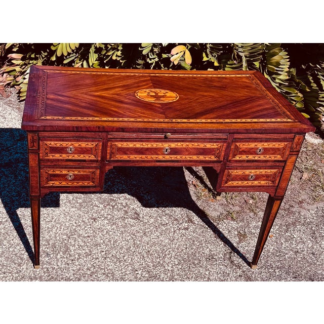 .18th Century Italian Neoclassical Inlaid Writing Desk. This desk features beautifully detailed marquetry, including a...