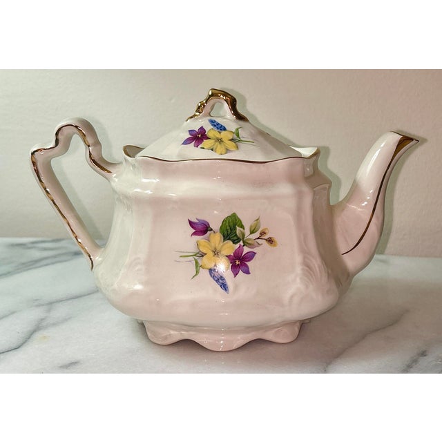 Arthur Wood & Son teapot, likely the "Dorset" model, featuring a floral design with yellow and purple flowers and gold...