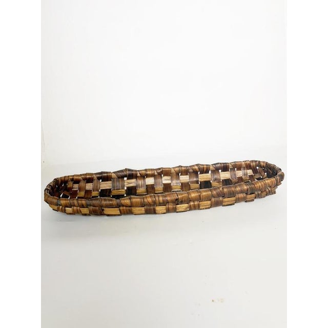 Oval woven wicker basket suitable for use as a bread basket, fruit basket, or centerpiece; France, 20th century. Crafted...