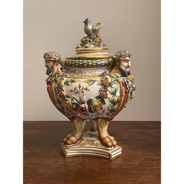 Ceramic potiche, 19th century Elegant ceramic with a triangular base, faceted, richly decorated with floral motifs, and...