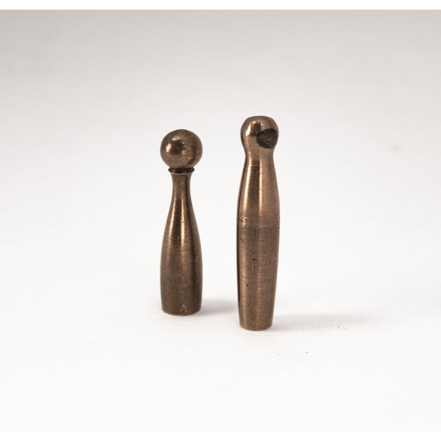 These brass game pieces for the game "Mensch ärgere dich nicht" feature a classic design. The set was produced in the...
