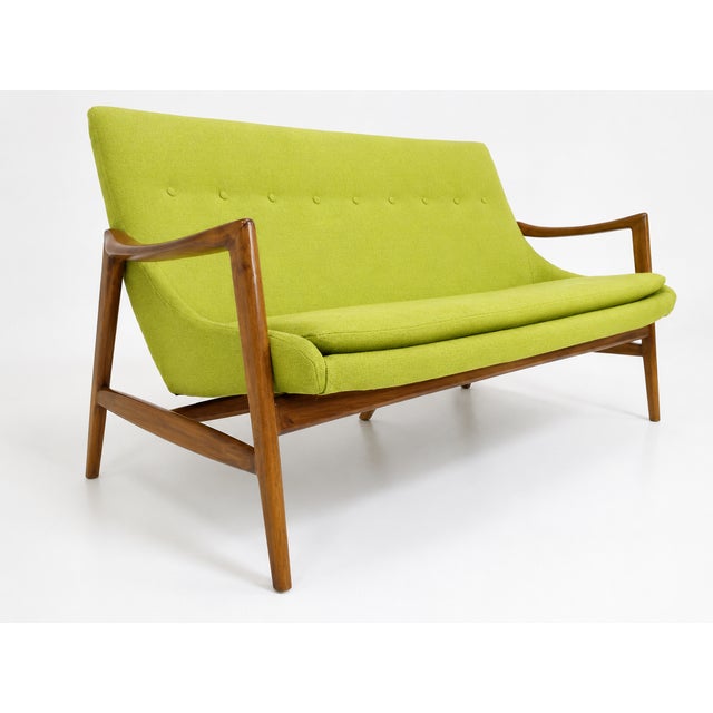 Mid-century-style sofa. The sofa was made in the style of Ib Kofod-Larsen. The sofa is stained a light walnut, matte...