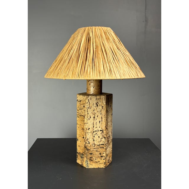 Gorgeous hexagonal cork table lamp base from Germany 1970s in the style of Ingo Maurer with new raffia shade. The lamp is...