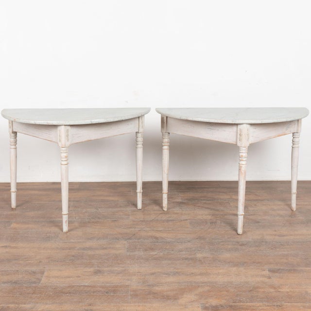 Pair of 19th century Swedish demi lune side table consoles, crafted in pine. Both have been given a newer professionally...