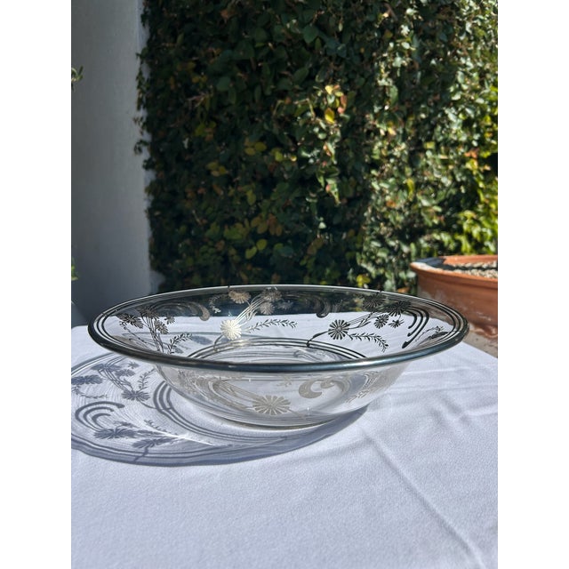 Vintage sterling bowl with engraved floral and scroll motif around the rim. Round form with shallow profile and raised...