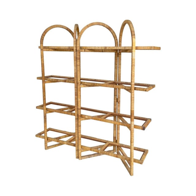 Stunning rattan wrapped etagere with ample room for display. The whole piece is in excellent vintage condition with minor...