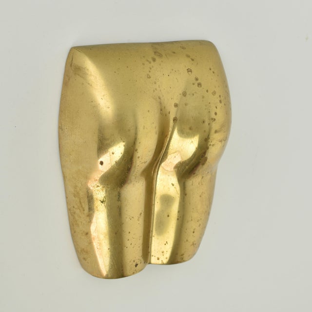 Mid century modern solid brass nude sculpture from the 1970s. This piece was made to be hung on the wall. Rare eye...