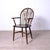 Description: Antique 19th-century English Windsor chair in wood, with a wheel-shaped backrest and armrests. Dimensions:...