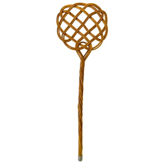 A beautifully handwoven vintage rattan rug beater that is as sculptural as it is nostalgic. Featuring an intricate...