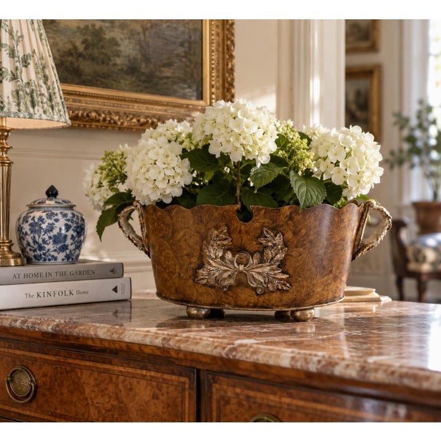 A handsome late 20th-century tole cachepot finished in a richly mottled faux bois pattern, giving the metal surface the...