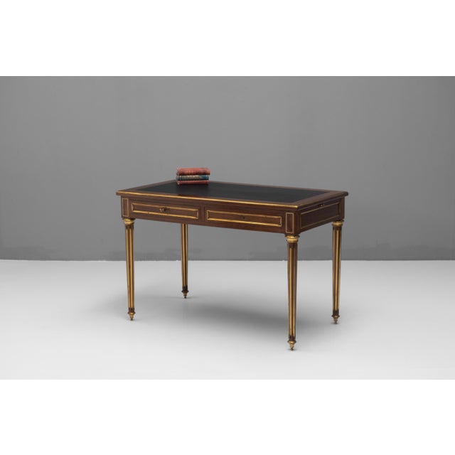 French mahogany brass bound bureau plat with pull out slides. Circa 1890.