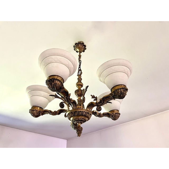 Large five-light bronze chandelier, inspired by the Louis XV style, with frosted glass shades featuring graphic details,...
