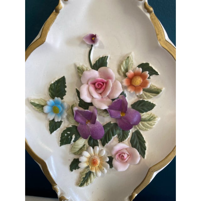 Beautiful floral ceramic decor by Lefton. It has 3D flowers on a white background with gold edges.