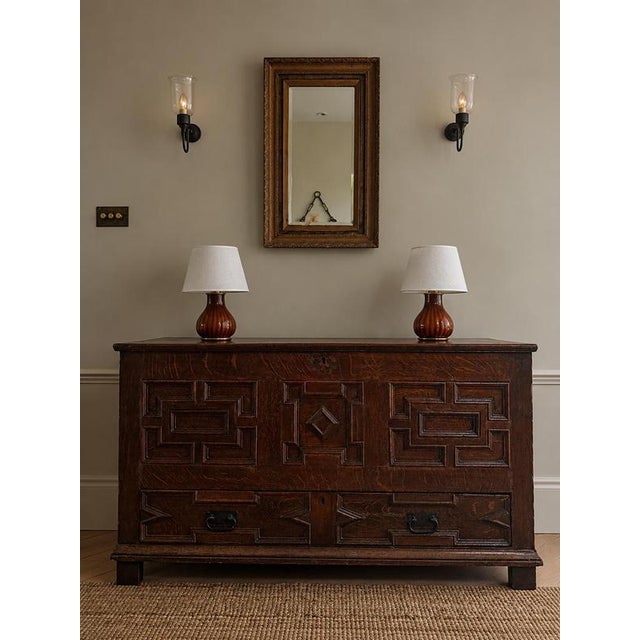A late 17th-century English oak geometric chest from the Charles II / Jacobean period, with a rich dark patina and...