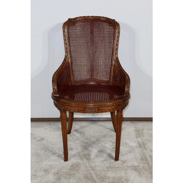 Louis XVI style armchair with solid beech structure and caning in perfect condition. This headquarters have a curved file...