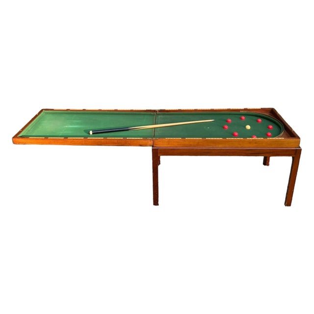 A late 19th century mahogany cased bagatelle table, which opens to a green felted billard game, complete with nine balls...