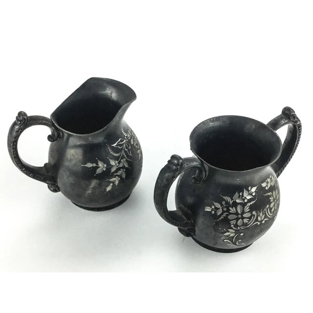 No polish on purpose. This beautiful set of cream and sugar carafes are USA produced and in excellent condition. Quite...