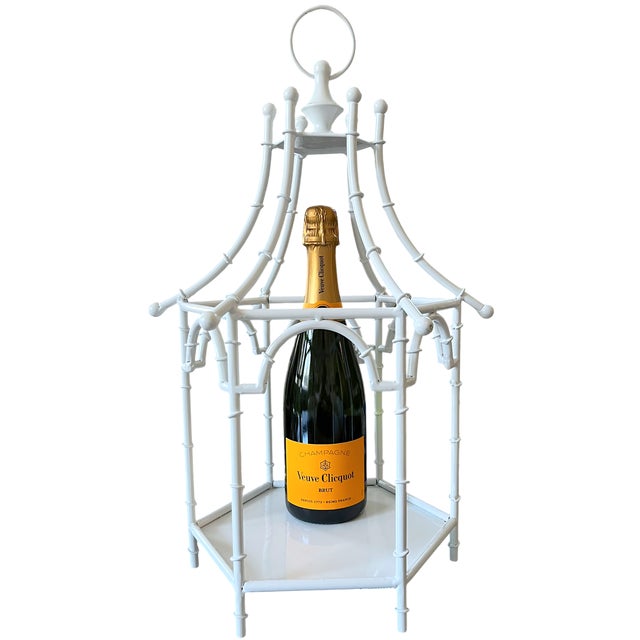 An architectural centerpiece with a striking pagoda silhouette, this large white painted-metal lantern combines faux...