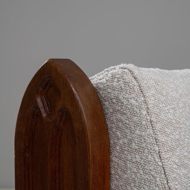 Pair of 1970s French Brutalist Upholstered Armchairs with Carved Details. These striking French armchairs embody the bold...