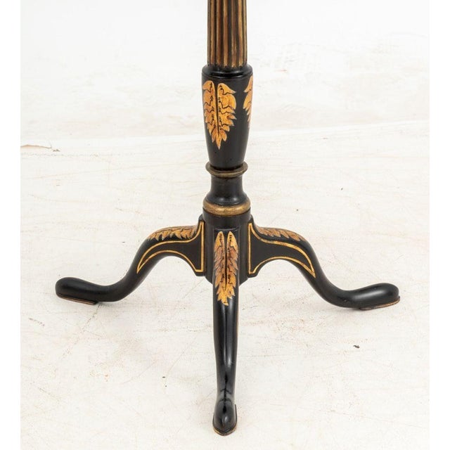 Regency Style Ebonized and Gilt Painted Wood Tripod Table, 19th century, the octagonal top with gilt tooled leather...