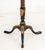 Regency Style Ebonized and Gilt Painted Wood Tripod Table, 19th century, the octagonal top with gilt tooled leather...