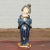 A Chinese vintage statue of a court lady dressed in a blue kimono and holding a swaddled baby. Tilting her head slightly...