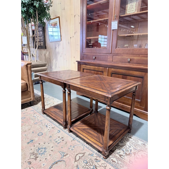 This is a striking pair of Jonathan Charles end tables featuring geometric parquetry tops framed by a molded edge in a...