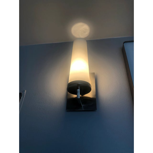 Stunning Transitional Sconce....stands at attention whether in your entry or over a shelving unit! Tapered frosted glass...