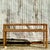 This vintage coastal console table, crafted from woven rattan, brings natural warmth and texture to any space. Its airy...