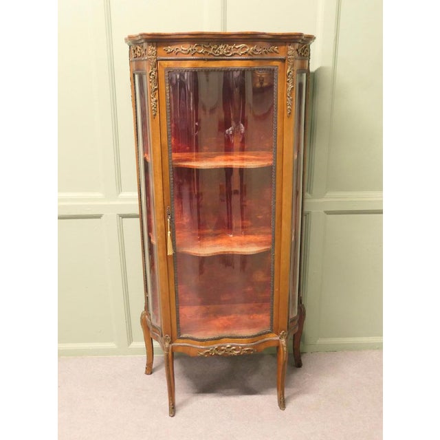 French Walnut and Ormolu Mounted Vitrine This is a superb piece of French display furniture, the cabinet has a serpentine...