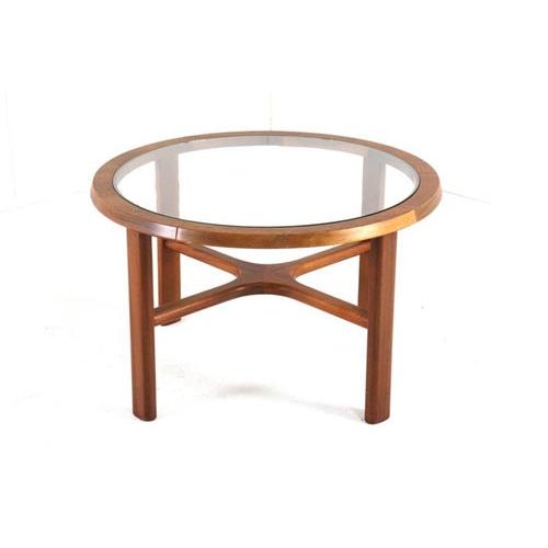 Beautiful round vintage coffee table with a glass top. This English-made coffee table is in neat and original vintage...