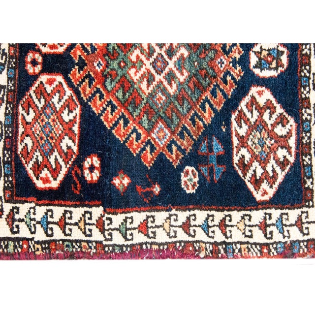 A beautiful early 20th century Persian Qashqai rug with a central stylized floral medallion amidst a field of even more...