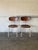 These versatile stacking chairs feature contoured plywood shells paired with sturdy white tubular steel frames. Their...