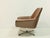 Elegant vintage swivel chair from the 1970s with a striking, organic design and exceptional seating comfort. The chair is...