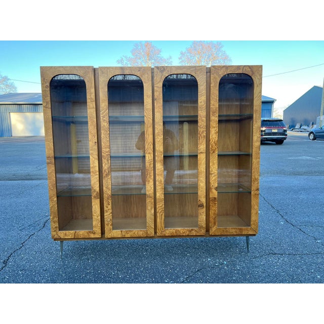 This exceptional vintage display cabinet is a true one-of-a-kind statement piece, crafted in the mid-century modern style...