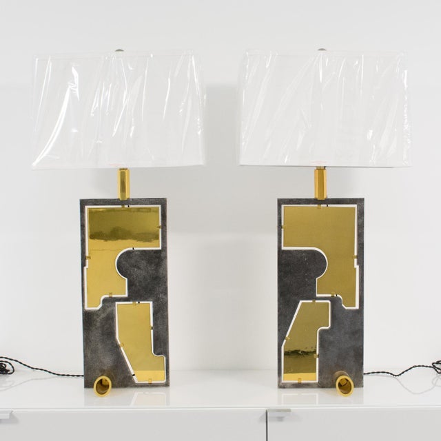 This extraordinary pair of industrial-flair table lamps has a unique design. The rare pieces were crafted in France circa...