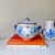 Vintage mid-century modern Bitossi pottery blue floral soup tureen with blue and green floral and starburst painted pattern.