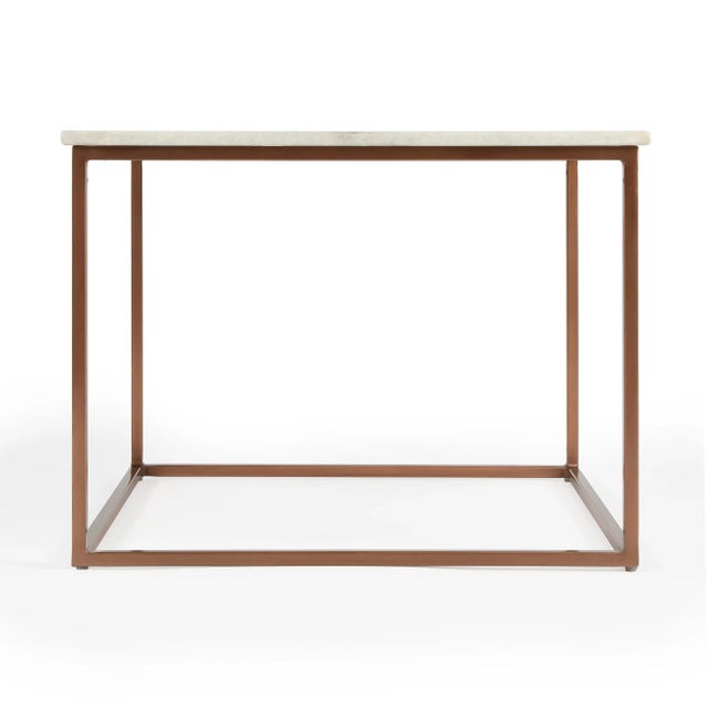 Serve drinks on this quaint cocktail table. Perfect for the living room or den, this tableâ€™s white marble tabletop rests...