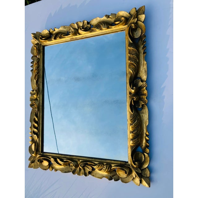 This hand carved mirror was made in Florence in the 50’s The mirror is hand gilded in gold leaf The mirror is original...