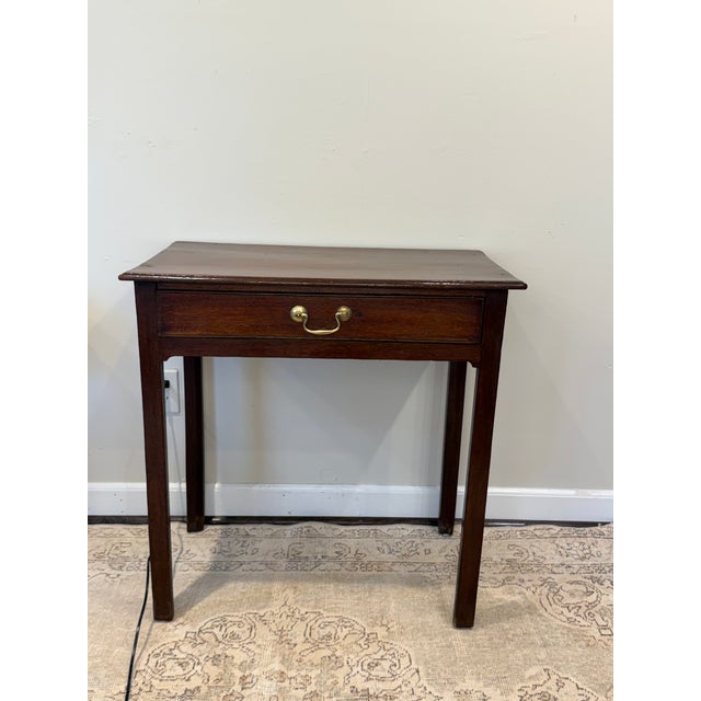 This sweet English side table features a storage drawer with a lovely brass pull. The finish has a rich character and a...