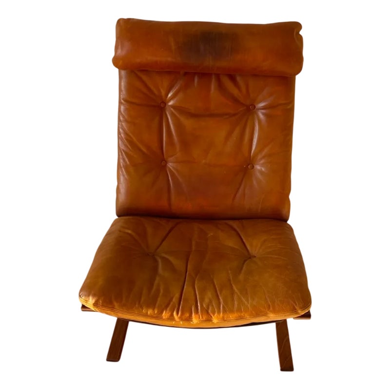 Brown leather chair with tufted seat and backrest